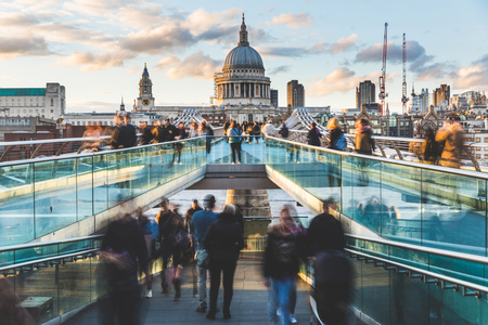 London and St Paul Cathedral at sunset, with blurred people walking on the bridge. Long exposure image with crowd visiting London. Travel, tourism and architecture conceptsの写真素材