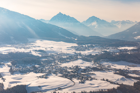 Aerial snow panorama in Austria aith Alps on background. Panoramic view of snow covered countryside in Austria. Travel and winter conceptsの写真素材