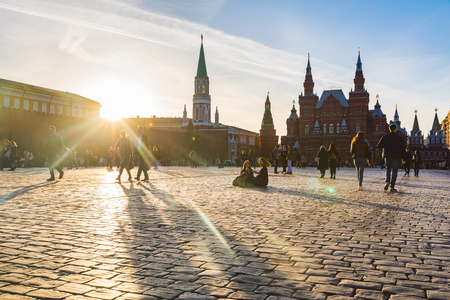 MOSCOW, RUSSIA - APRIL 9, 2018: People, tourists, in the Red Square at sunset. Kremlin building on the left and the State Historical Museum on the right. Travel and architecture are the main conceptsのeditorial素材