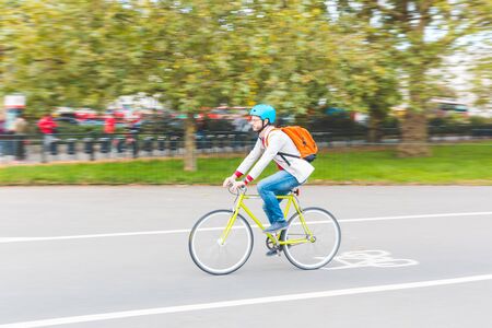 Hipster man cycling in London park - Young business man riding a fixed gear bike and wearing a helmet - Panning technique, sustainable transportation and lifestyle conceptsの写真素材