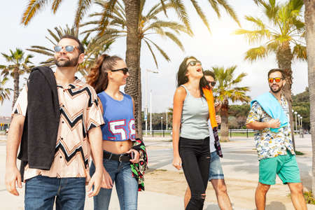 Happy friends on seaside walk in Barcelona - Multiracial group of best friends enjoying summer and time together - Happiness and friendship during a travel in Spainの写真素材