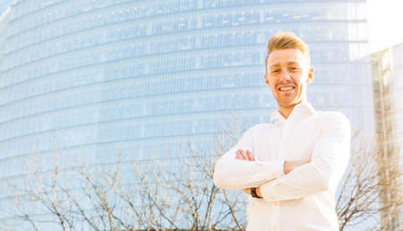 Young businessman portrait with modern buildings on background - Smiling and successful young entrepreneur in London - Business and start up conceptsの写真素材