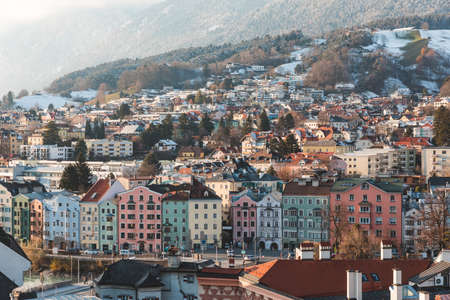 Innsbruck aerial panoramic view on winter day - Colorful houses and mountains covered by snow in the historic city centre of Innsbruck, Austria - Travel and architecture conceptsの写真素材