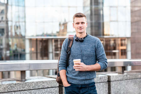 Portrait of a man in London with modern buildings on background - Smilling and cheerful caucasian man alone in the city - Lifestyle in capital cityの写真素材