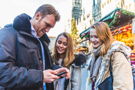 Happy friends at Christmas market in Munichの写真素材