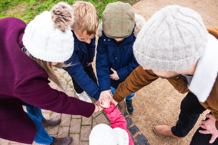 Family teamwork with parents and children hands on stack - Family of five with boys and girl making...