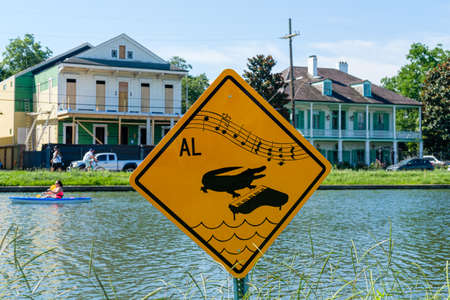Alligator with piano sign on Bayou St. John in New Orleans, Louisiana, USAのeditorial素材