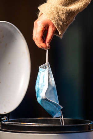 Dropping and throwing a delta mask in a bin and the trash in Australia.