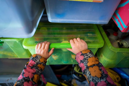 gril packing up a shed in storage containers. woman packing for camping in australiaの写真素材