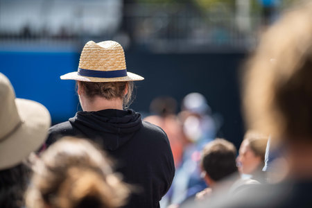 tennis fan watching a tennis match at the australian open eating food and drinking
