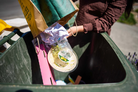 sorting recycling and rubbish in bins in hobart tasmania australia in town