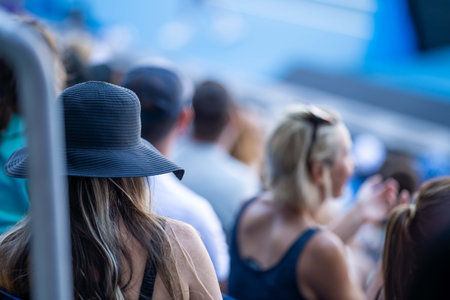 tennis fan watching a tennis match at the australian open eating food and drinking in melbourne australiaの写真素材