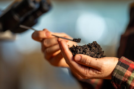 young Female soil scientist holding a soil in a hand in a soil laboratory in australiaの写真素材