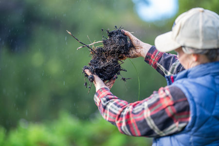 female farmer holding soil looking at soil carbon in the america
