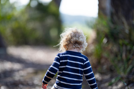 baby in the wild forest together walking in a park in australiaの写真素材