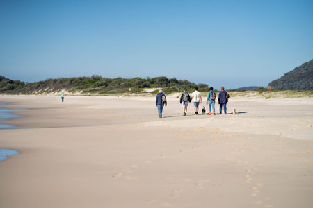 walking on the beach at dusk on an australian sandy beach in summerの写真素材