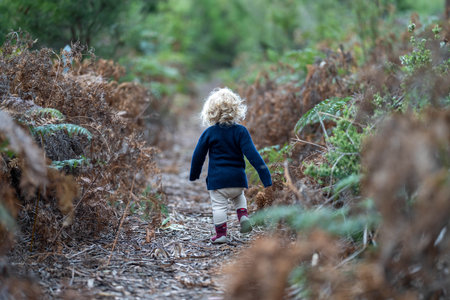 baby in the wild forest together walking in a park in americaの写真素材