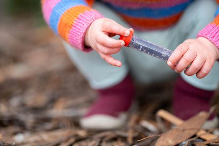kid with test tube outsideの写真素材