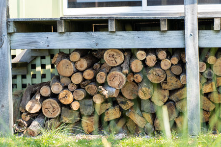 Pile of stacked fire wood in a Garden by a house in Tasmania Australiaの写真素材