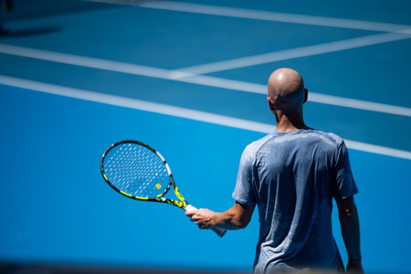 tennis player drying off with a towel on a tennis court in summer in australiaの写真素材