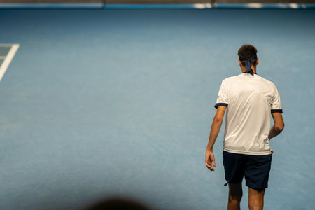 playing tennis at a tournament and match on blue hard courtの写真素材
