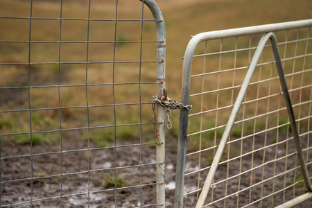 shut farm gate on a fence line on a livestock farm in australiaの写真素材