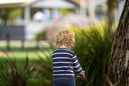 Cute little boy playing in the park on a sunny day.の写真素材