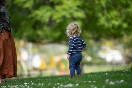 Cute little toddler boy walking in the park on a sunny dayの写真素材
