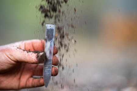 taking a soil sample for a soil test in a field. Testing carbon sequestration and plant health in...