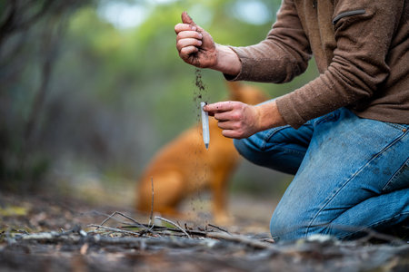 farmer holding soil in hand and pouring soil on ground. connected to the land and environment. soil...