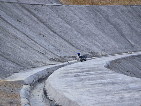 Mine slope stabilization process with geosynthetics and shotcrete.