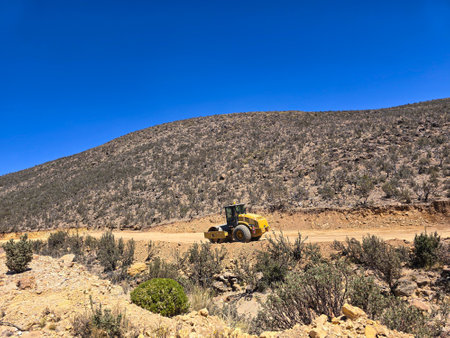 Road construction with heavy machinery in the high Andean mountains.