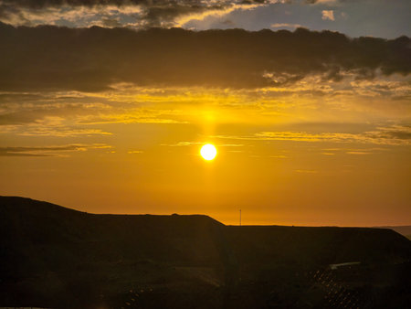 Sunset in the high mountains seen from inside a fence.の写真素材