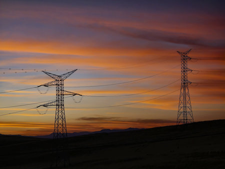 High voltage towers at sunset with beautiful clouds.の写真素材
