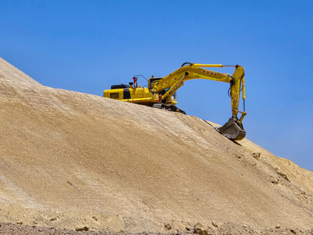 Excavation and profiling of slopes and platforms with heavy machinery in a mine.の写真素材