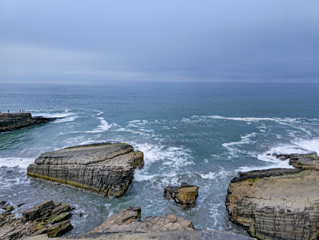 Bay with cliffs and rock islets and many waves.の写真素材