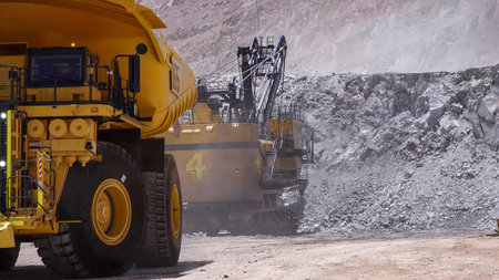 Heavy mining machinery extracting minerals in an open pit mineの写真素材