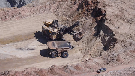 Heavy mining machinery extracting minerals in an open pit mineの写真素材