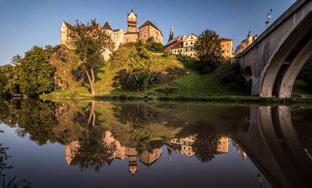 Panoramic view of castles and bridge across the river at sunsetの写真素材