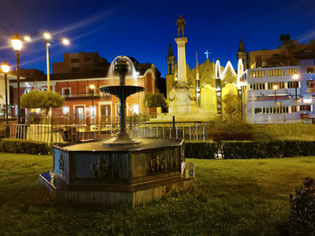 Square water fountain with church in the background.の写真素材