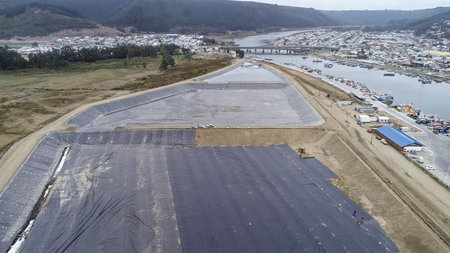 Geomembrane deployment and installation process with machinery in the construction of water poolsの写真素材