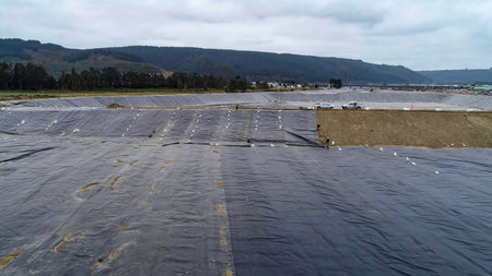 Geomembrane deployment and installation process with machinery in the construction of water poolsの写真素材