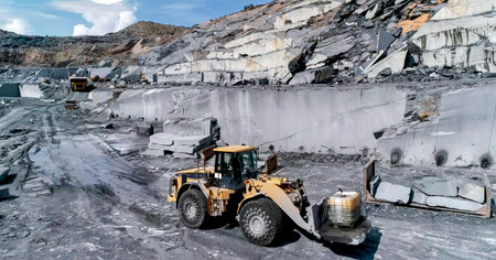 Mining machinery extracting ornamental rock in a quarry