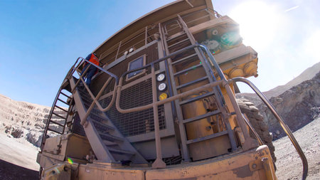 Giant mining truck transporting minerals in an open pit mineの写真素材