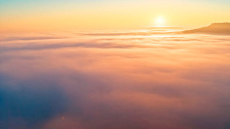 Sunrise view over the low clouds in the high Andean mountains