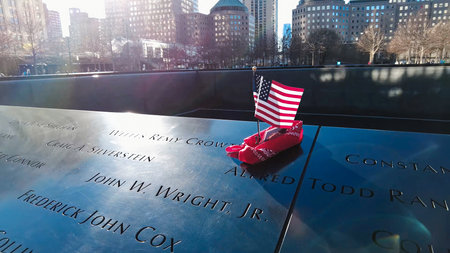 Small flag placed over names of people at the National September 11 Memorial & Museum