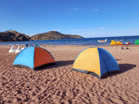 Beach view with many floating inflatables and tents for relaxing on a sunny afternoonの写真素材