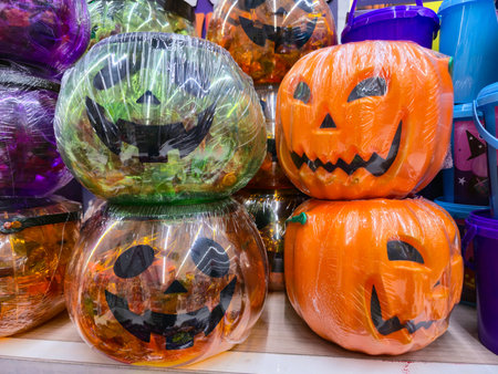 group of Halloween pumpkins filled with candy displayed for saleの写真素材