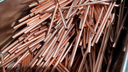 Accumulation tray for sections of manufactured copper pipes for the construction of air conditioning equipment.の写真素材
