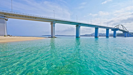 View of a marine bay with a bridge and turquoise watersの写真素材